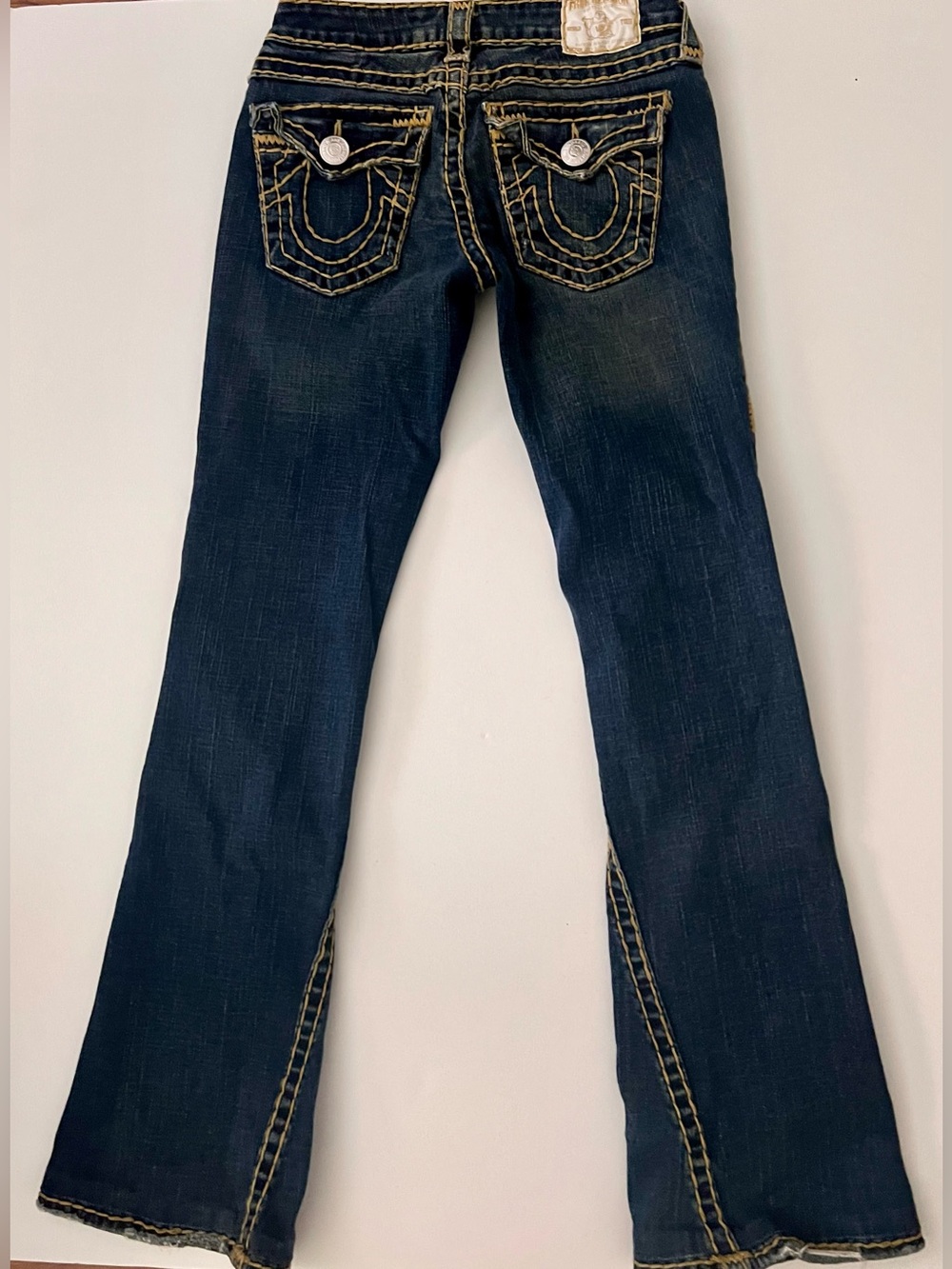 True Religion low rise bootcut jeans in navy blue with gold stitching, size 27